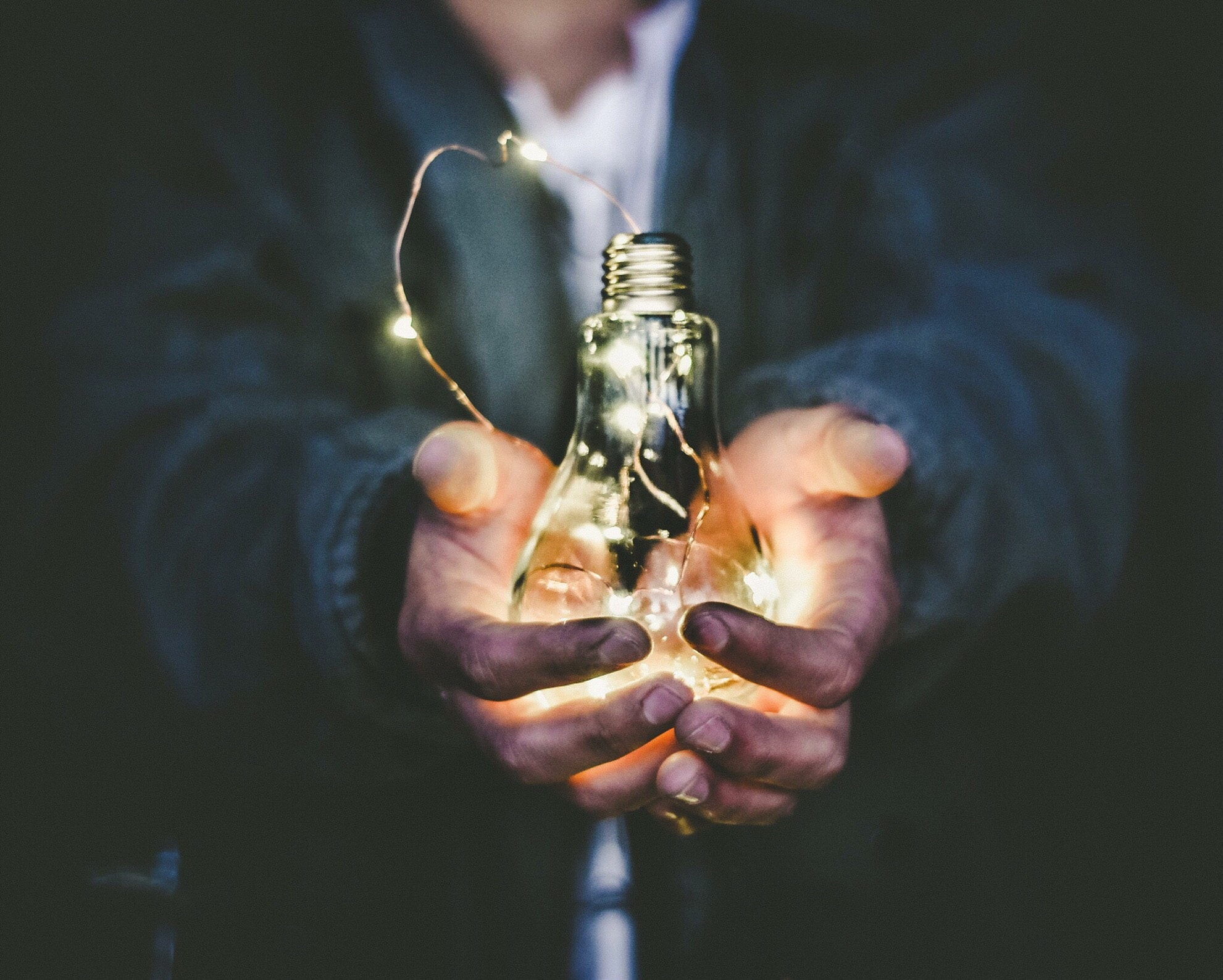 Picture of a man holding a light bulb